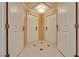 Hotel hallway with 4 white doors, a diamond tiled floor, and a decorative light fixture in a square ceiling inset at 145 E Harmon Ave # 3101, Las Vegas, NV 89109