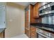 Compact kitchenette with stainless steel appliances, sleek countertops, and wooden cabinets, blending functionality with style at 145 E Harmon Ave # 3101, Las Vegas, NV 89109