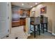 Elegant kitchenette featuring wood cabinetry, stainless steel appliances, and stylish seating for a convenient dining experience at 145 E Harmon Ave # 3101, Las Vegas, NV 89109