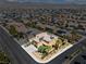 Aerial view of a two-story home with solar panels, a three-car garage, and desert landscaping at 1776 Gentle Brook St, North Las Vegas, NV 89084