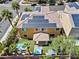 Aerial view of a two-story home with solar panels, a backyard pool and hot tub, and desert landscaping at 1776 Gentle Brook St, North Las Vegas, NV 89084