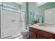 Bright bathroom featuring a walk-in shower with glass door and single sink vanity at 1776 Gentle Brook St, North Las Vegas, NV 89084