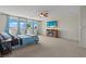 Bright bedroom with a ceiling fan, palm tree view, and an entertainment center at 1776 Gentle Brook St, North Las Vegas, NV 89084
