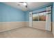 Neutral bedroom with carpet flooring, a ceiling fan, and natural light streaming through the window at 1776 Gentle Brook St, North Las Vegas, NV 89084