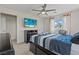 Comfortable bedroom featuring a ceiling fan, television, and natural light from the window at 1776 Gentle Brook St, North Las Vegas, NV 89084