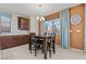 Cozy dining area with a dark wood table, stylish lighting, and large windows offering natural light at 1776 Gentle Brook St, North Las Vegas, NV 89084