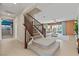 Inviting entryway with stairs leading to the living room and showcasing natural light and open floor plan at 1776 Gentle Brook St, North Las Vegas, NV 89084