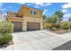 Two-story stucco home featuring a three-car garage and desert landscaping at 1776 Gentle Brook St, North Las Vegas, NV 89084