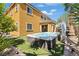 Beautiful backyard oasis with an inviting stone-surround spa with lush landscaping and ample sunlight at 1776 Gentle Brook St, North Las Vegas, NV 89084