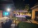 Backyard oasis featuring two hot tubs, custom stone surround, covered patio and mature palm trees at 1776 Gentle Brook St, North Las Vegas, NV 89084