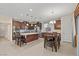 Bright kitchen with a large island, stainless steel appliances, and a dining area with a dark wood table at 1776 Gentle Brook St, North Las Vegas, NV 89084