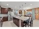 Spacious kitchen with granite counters, stainless appliances, and dining area featuring stylish lighting fixtures at 1776 Gentle Brook St, North Las Vegas, NV 89084