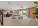 Open-concept living room with tile flooring, a ceiling fan, a large window and an open kitchen at 1776 Gentle Brook St, North Las Vegas, NV 89084