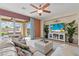 Living room with tile flooring, a ceiling fan, access to a patio with a hot tub, and a TV at 1776 Gentle Brook St, North Las Vegas, NV 89084