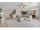 Open-concept living room with tile flooring, a ceiling fan, and a staircase leading to the second floor at 1776 Gentle Brook St, North Las Vegas, NV 89084