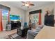 Cozy living room features a ceiling fan, natural light, and an entertainment center with TV at 1776 Gentle Brook St, North Las Vegas, NV 89084