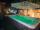 Enjoy an evening swim in this backyard spa featuring ambient lighting and mature palms at 1776 Gentle Brook St, North Las Vegas, NV 89084