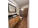 Well-lit bathroom featuring a granite vanity and tiled shower at 1830 N Buffalo Dr # 2098, Las Vegas, NV 89128