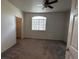 Neutral bedroom with a ceiling fan, carpet, and large window at 1830 N Buffalo Dr # 2098, Las Vegas, NV 89128