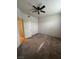 Neutral bedroom with a ceiling fan, carpet, and doorway to the hall at 1830 N Buffalo Dr # 2098, Las Vegas, NV 89128