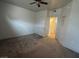 Neutral bedroom with a ceiling fan, carpet, and doorway to the closet at 1830 N Buffalo Dr # 2098, Las Vegas, NV 89128