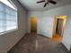 Neutral bedroom with a ceiling fan, carpet, and doorways to the closet and bath at 1830 N Buffalo Dr # 2098, Las Vegas, NV 89128