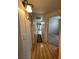 Hallway with wood floors leading to rooms in the condo at 1830 N Buffalo Dr # 2098, Las Vegas, NV 89128