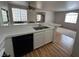 Kitchen open to dining and living room featuring white countertops and wood-look flooring at 1830 N Buffalo Dr # 2098, Las Vegas, NV 89128