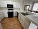 Kitchen featuring white cabinets, laminate countertops, and black appliances at 1830 N Buffalo Dr # 2098, Las Vegas, NV 89128