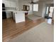 Bright living room featuring hardwood floors and a view of the kitchen and front entrance at 1830 N Buffalo Dr # 2098, Las Vegas, NV 89128