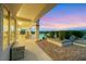 Expansive backyard featuring a covered patio, well-maintained landscaping, and stunning city views at 1960 Oliver Springs St, Henderson, NV 89052