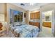 Comfortable bedroom with built-in cabinets, a window offering outdoor views, and an en-suite bathroom at 1960 Oliver Springs St, Henderson, NV 89052
