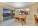 Dining area with tile flooring, chandelier, slider to patio, and view of living room at 1960 Oliver Springs St, Henderson, NV 89052