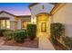 Welcoming front entrance featuring desert landscaping, pavers, lighting, and an inviting arched doorway at 1960 Oliver Springs St, Henderson, NV 89052