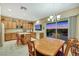 Open kitchen featuring wooden cabinets, island with seating, and sliding door to patio at 1960 Oliver Springs St, Henderson, NV 89052