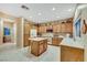 Cozy kitchen featuring wooden cabinets, tile floors, an island, and lots of natural light at 1960 Oliver Springs St, Henderson, NV 89052
