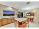 Kitchen with breakfast bar, wooden cabinets, and a view into the dining and living room at 1960 Oliver Springs St, Henderson, NV 89052