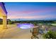 Beautifully landscaped pool area with serene lighting and comfortable seating, set against scenic views at 1960 Oliver Springs St, Henderson, NV 89052