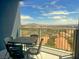 Cozy balcony with a table set perfect for enjoying stunning views of the mountains at 211 E Flamingo Rd # 1012, Las Vegas, NV 89169