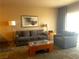 Comfortable living room with sofa, chair, stylish coffee table, and natural light at 211 E Flamingo Rd # 1012, Las Vegas, NV 89169