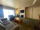 Cozy living room featuring fireplace, TV, sofa, and writing desk by a brightly lit window at 211 E Flamingo Rd # 1012, Las Vegas, NV 89169