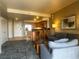 Open-concept living room with kitchen, bar seating, and comfortable seating arrangement at 211 E Flamingo Rd # 1012, Las Vegas, NV 89169