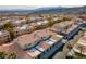 Scenic aerial view of a townhouse community with terracotta roofs, carports, and desert landscaping against a mountain backdrop at 2219 Rugged Mesa Dr, Laughlin, NV 89029
