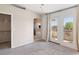 Sunny bedroom showcasing an ensuite bathroom, walk-in closet, and access to a private balcony at 2219 Rugged Mesa Dr, Laughlin, NV 89029