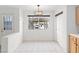 Sunny dining area with tile floors, large window, and modern lighting fixture at 2219 Rugged Mesa Dr, Laughlin, NV 89029