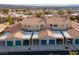 An aerial view of multiple attached homes featuring private garages and community parking at 2219 Rugged Mesa Dr, Laughlin, NV 89029