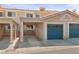 Charming home exterior with carport and blue garage door at 2219 Rugged Mesa Dr, Laughlin, NV 89029