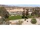 Exterior shot of community buildings featuring well-maintained landscaping, desert plants, and walking paths at 2219 Rugged Mesa Dr, Laughlin, NV 89029