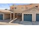 Attached garages with blue doors offer convenient parking for community residents at 2219 Rugged Mesa Dr, Laughlin, NV 89029
