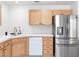 Bright kitchen featuring stainless steel appliances, wood cabinets, and tile countertops at 2219 Rugged Mesa Dr, Laughlin, NV 89029